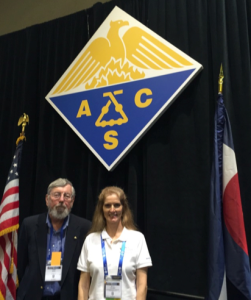Dena Chubbic and John Berg with ACS symbol and American flag