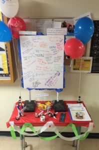 table with whiteboard on it. the whiteboard is filled with student comments
