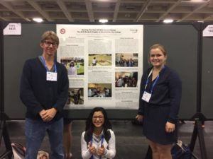three people posing around poster