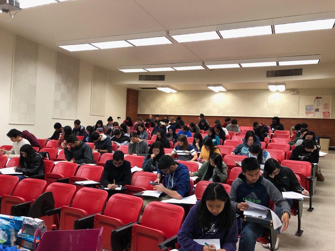 Students taking exam in lecture hall