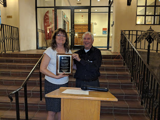 two people standing with award plaque