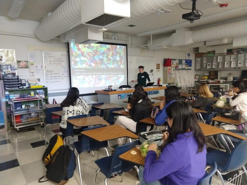 Woman talks to class of students